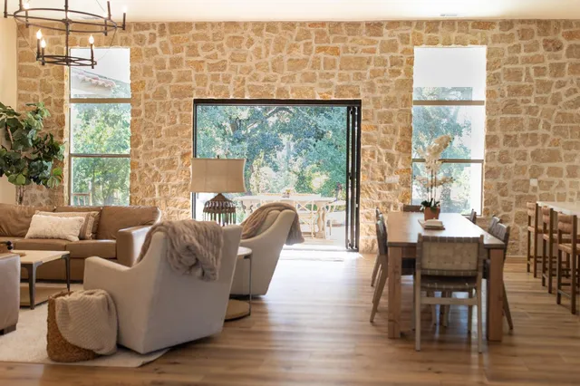 a living room with furniture and a floor to ceiling window