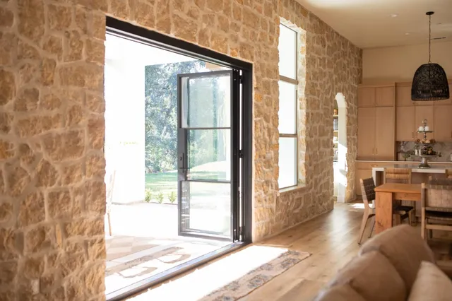 a living room with furniture and a floor to ceiling window