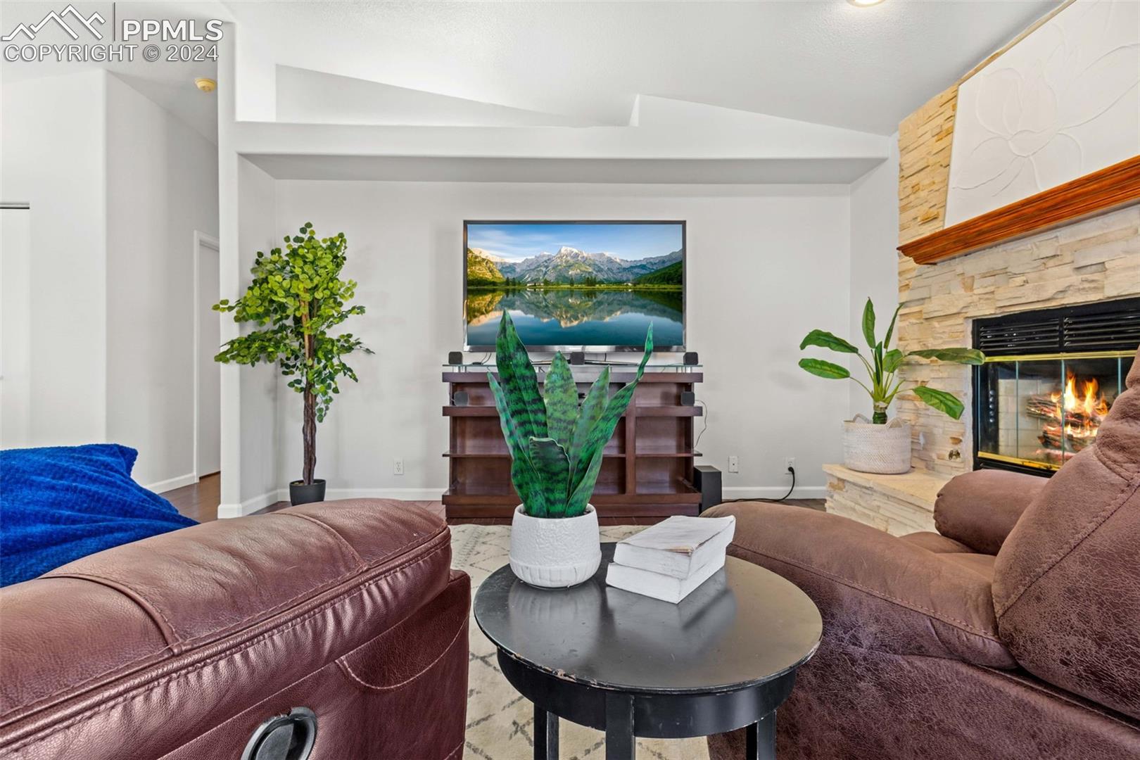 17650 Fremont Fort Road Peyton, CO 80831 - Photo 14 of 41 Living room featuring a fireplace and vaulted ceiling