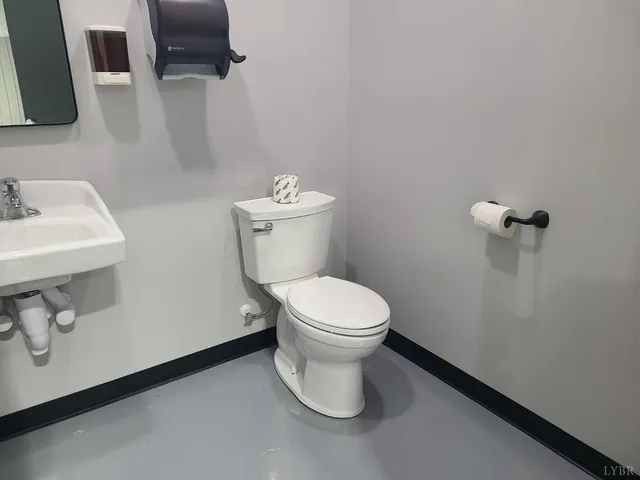 a white toilet sitting next to a bathroom sink