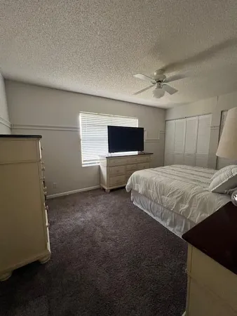 a bedroom with a bed and a television