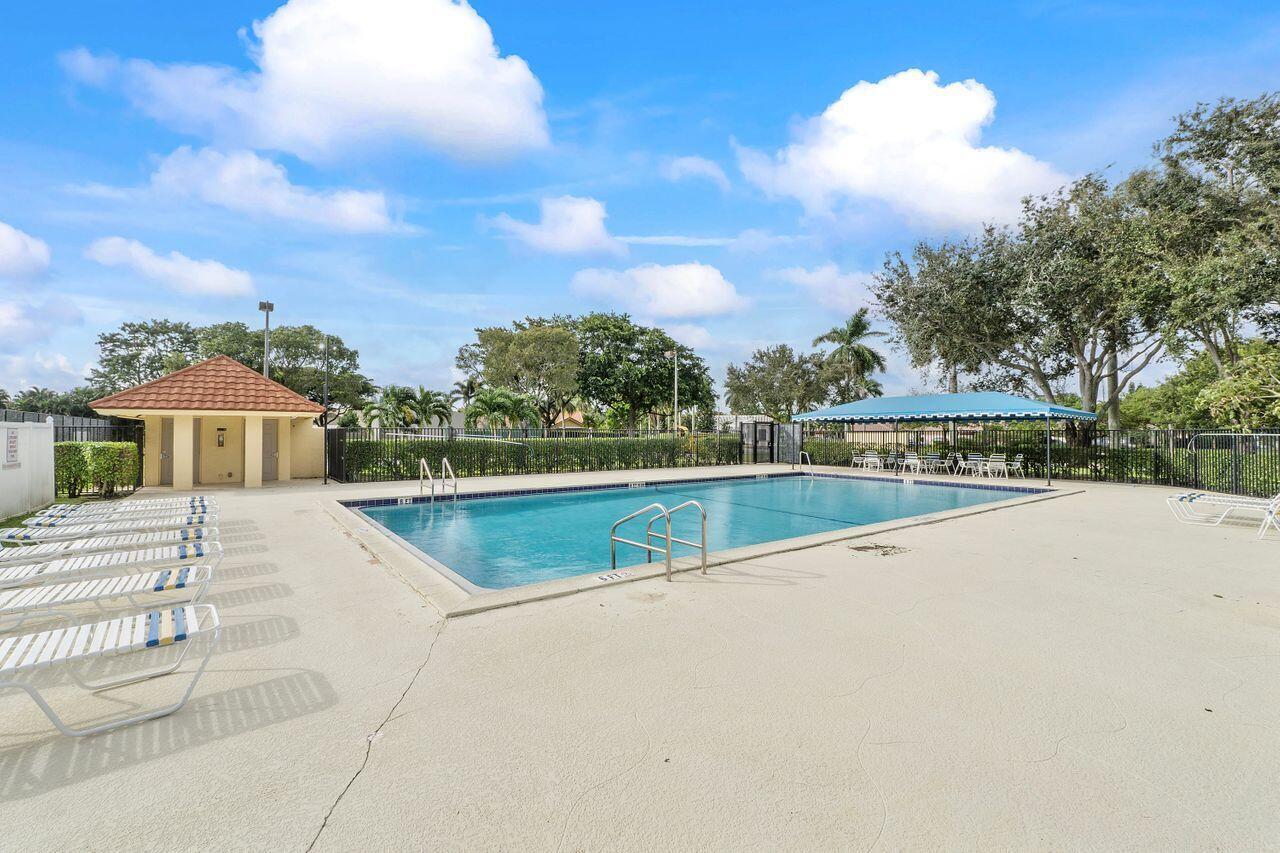 9775 Sun Pointe Drive Boynton Beach, FL 33437 - Photo 26 of 30 a view of swimming pool with a yard