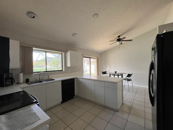 a large white kitchen with a large window
