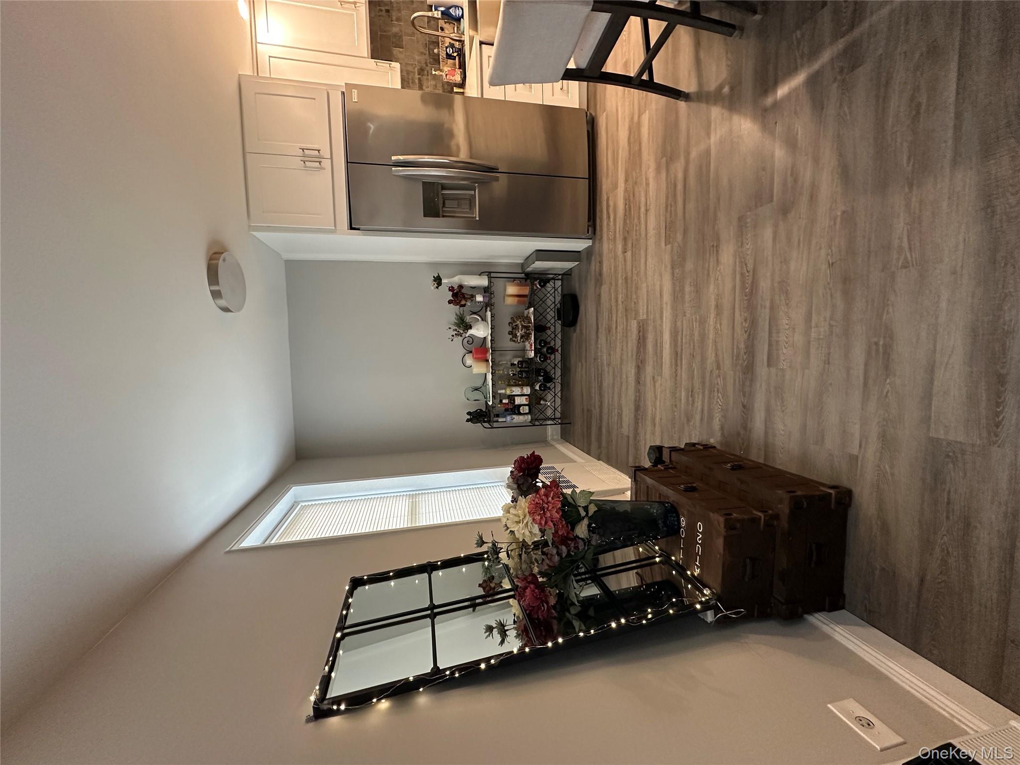 241-20 Northern Boulevard, Unit 1M Queens, NY 11362 - Photo 12 of 31 a living room with furniture and a flat screen tv