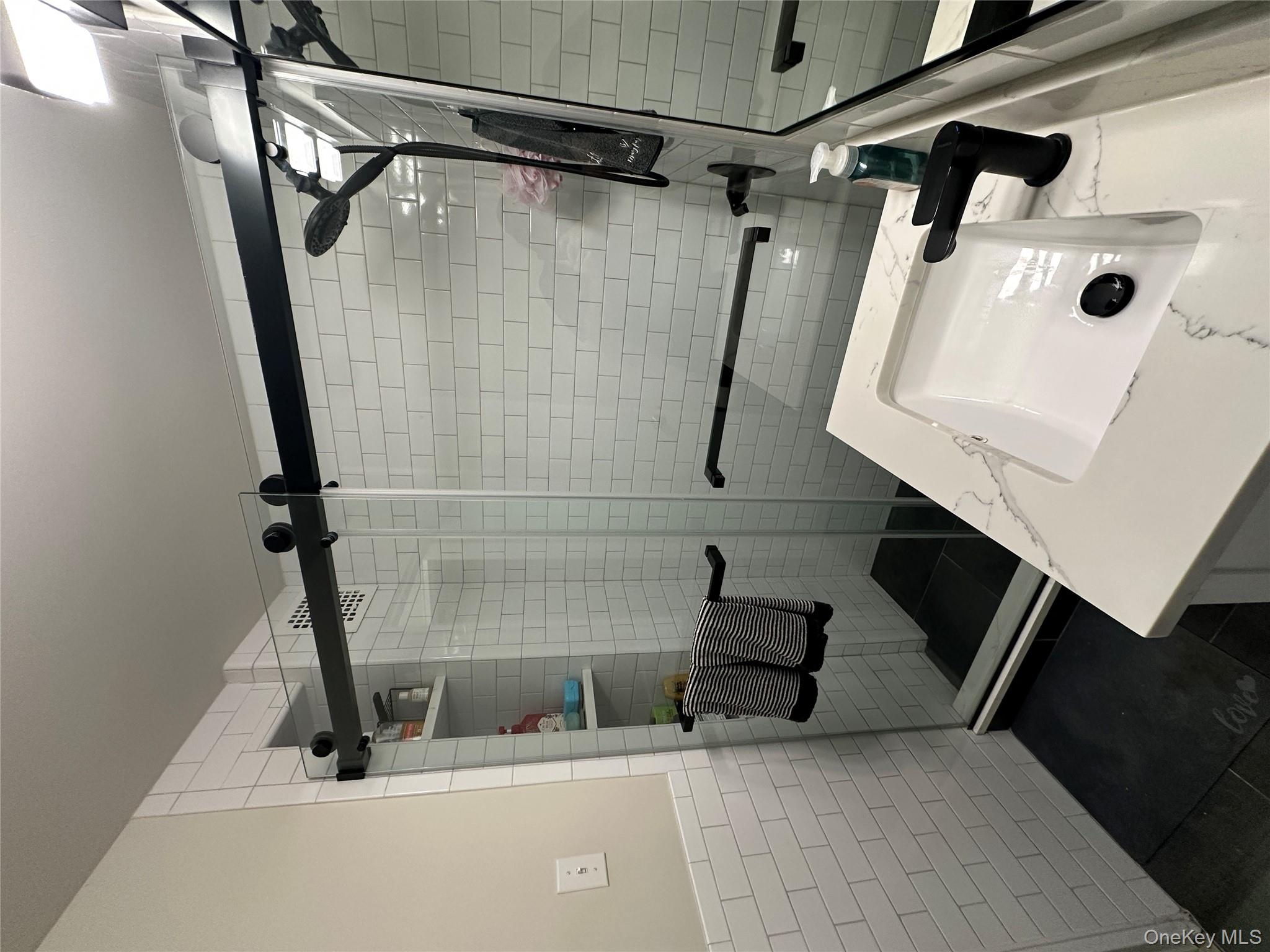 241-20 Northern Boulevard, Unit 1M Queens, NY 11362 - Photo 14 of 31 a bathroom with a sink and a shower