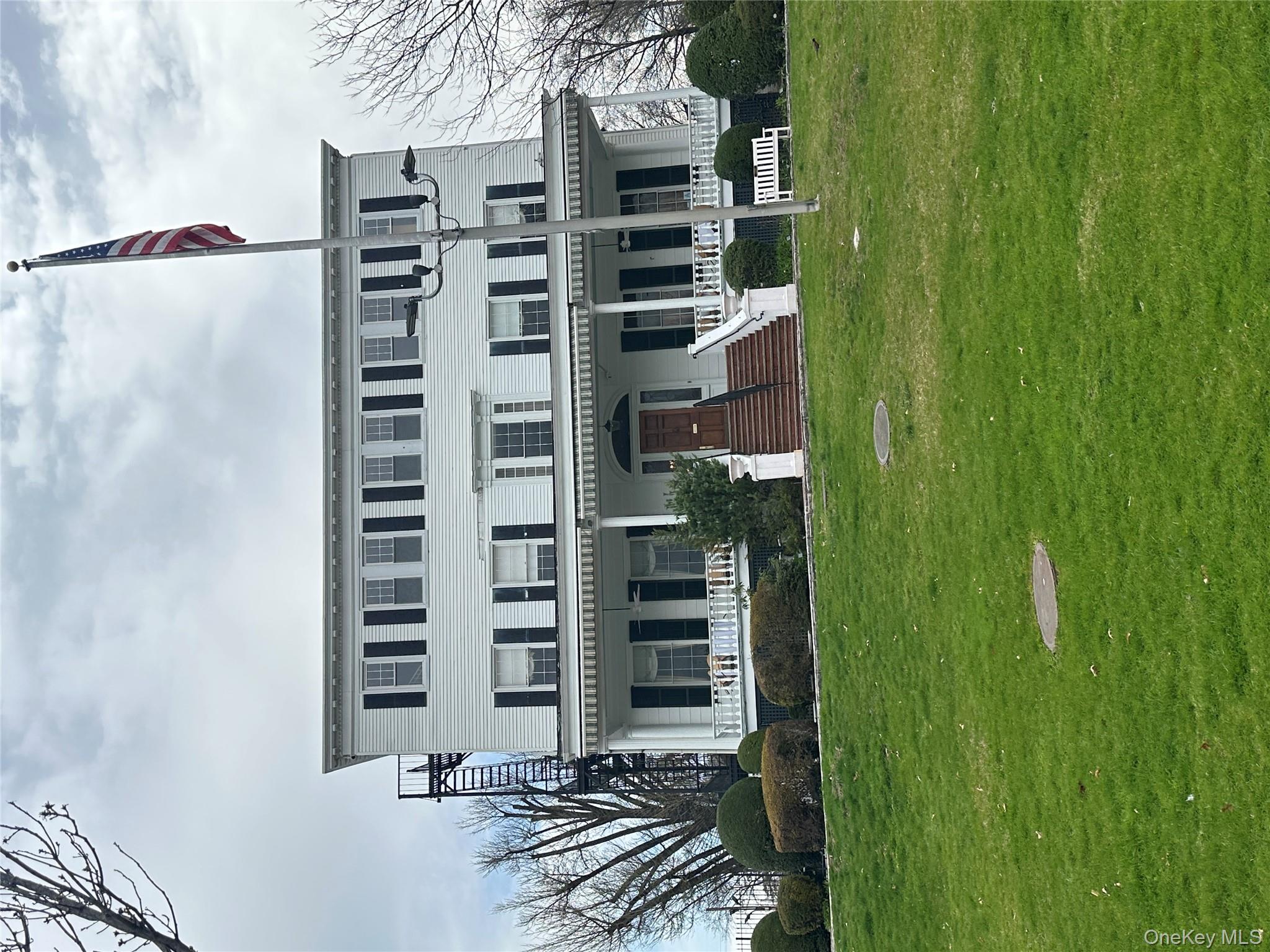241-20 Northern Boulevard, Unit 1M Queens, NY 11362 - Photo 16 of 31 a view of a house with a deck