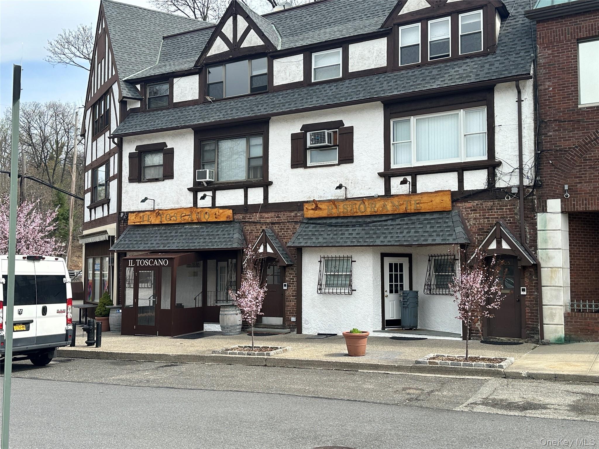 241-20 Northern Boulevard, Unit 1M Queens, NY 11362 - Photo 23 of 31 a front view of a building and car parked