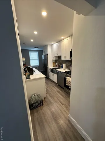 a kitchen with sink refrigerator and cabinets
