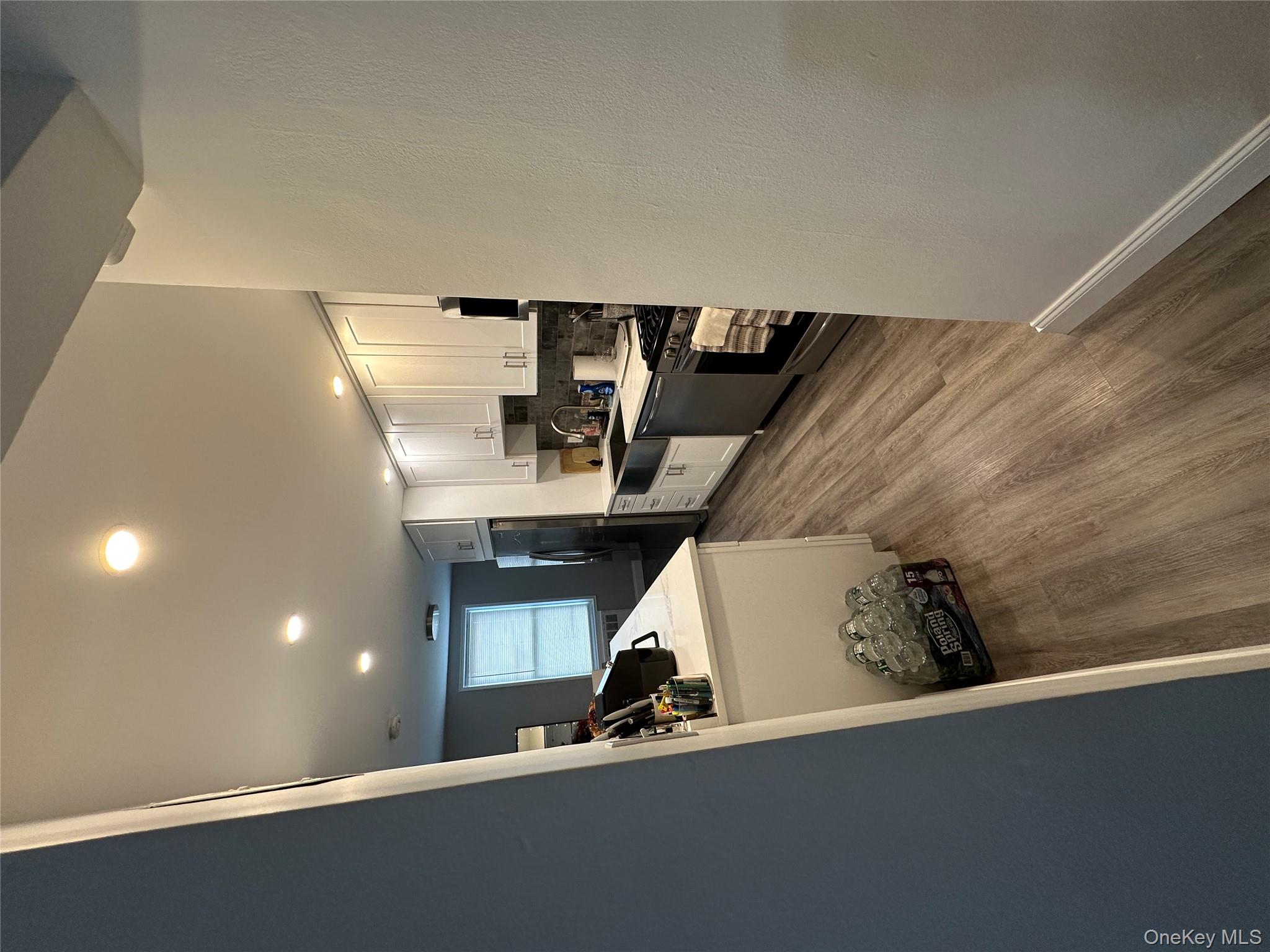 241-20 Northern Boulevard, Unit 1M Queens, NY 11362 - Photo 27 of 31 a kitchen with sink refrigerator and cabinets