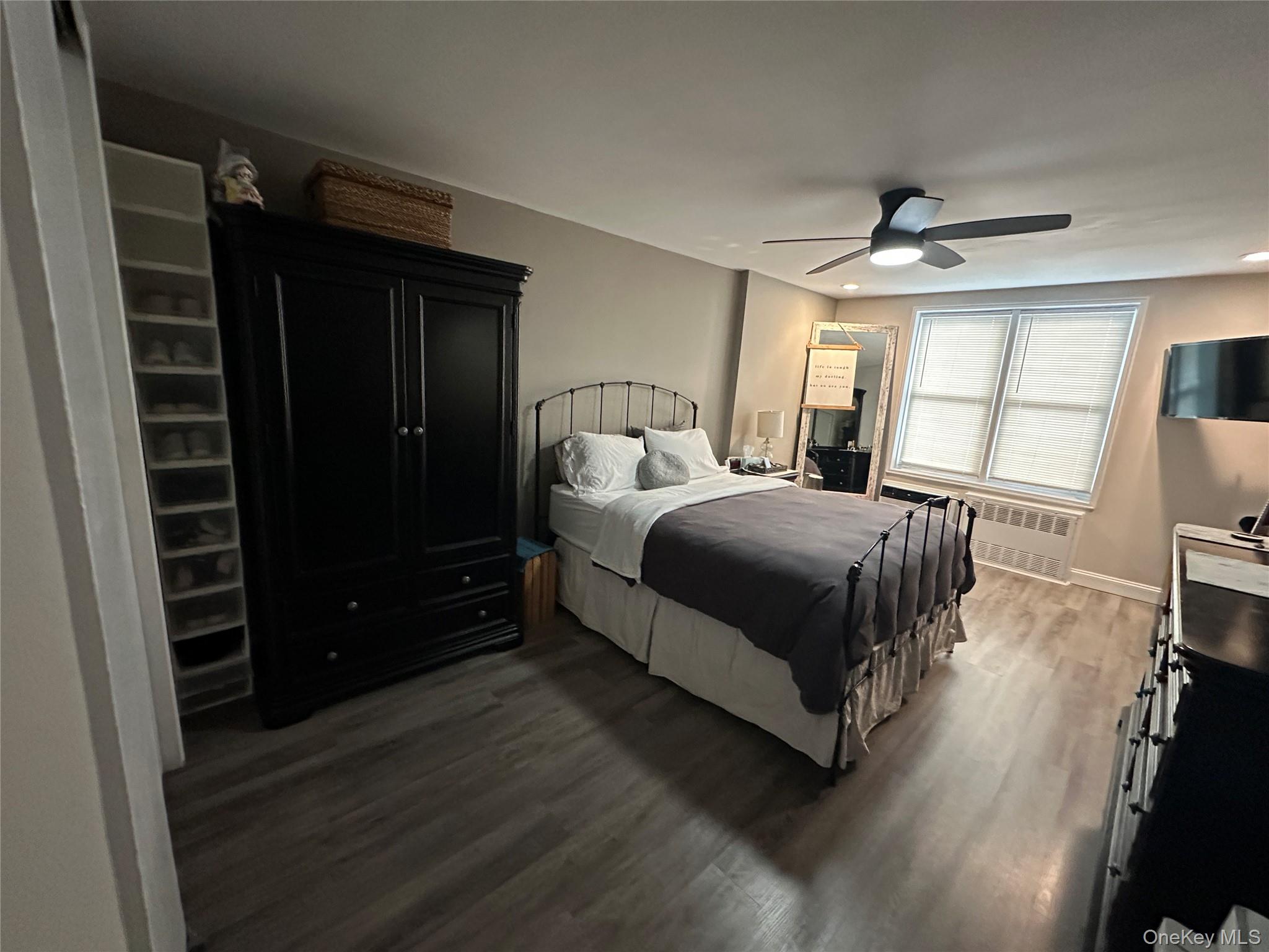 241-20 Northern Boulevard, Unit 1M Queens, NY 11362 - Photo 4 of 31 a bedroom with a bed window and a mirror