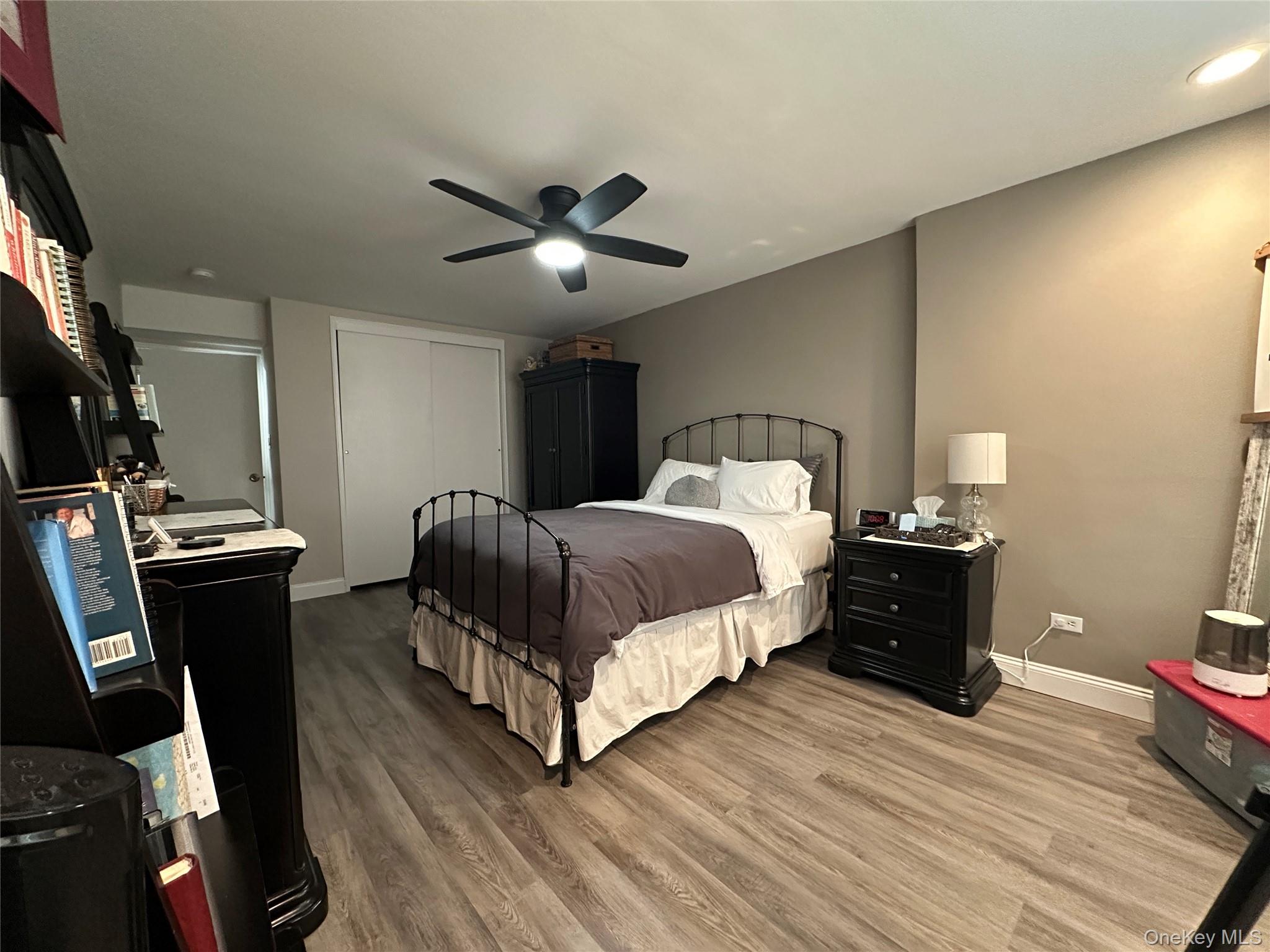 241-20 Northern Boulevard, Unit 1M Queens, NY 11362 - Photo 5 of 31 a bedroom with a bed and a chandelier