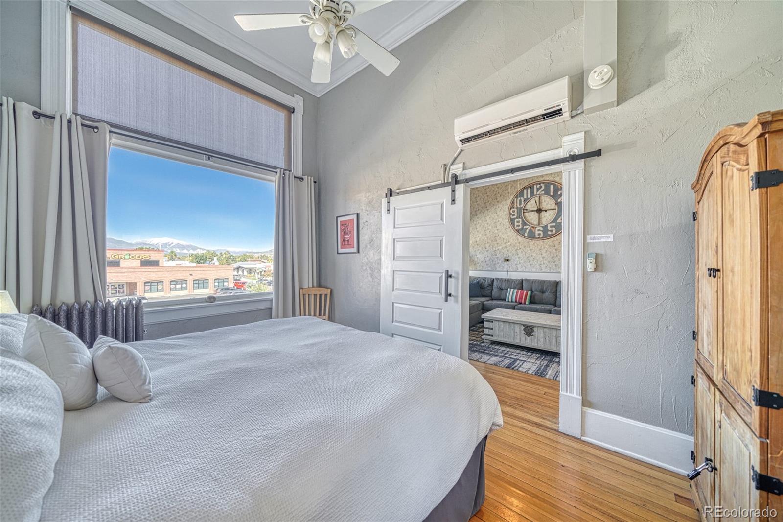207 F Street, Unit 2 Salida, CO 81201 - Photo 19 of 23 a bedroom with a bed and a large window