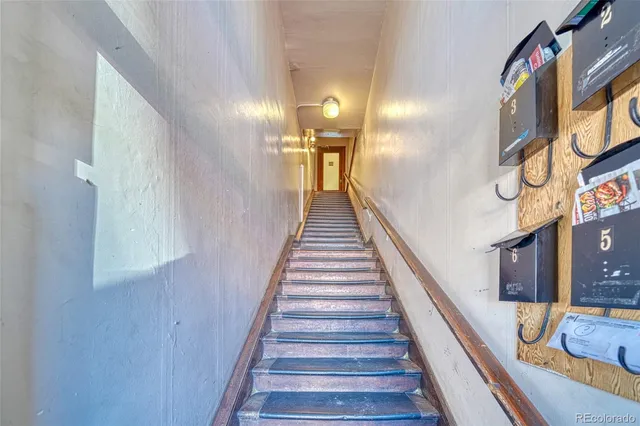 a view of a room with wooden floor and stairs