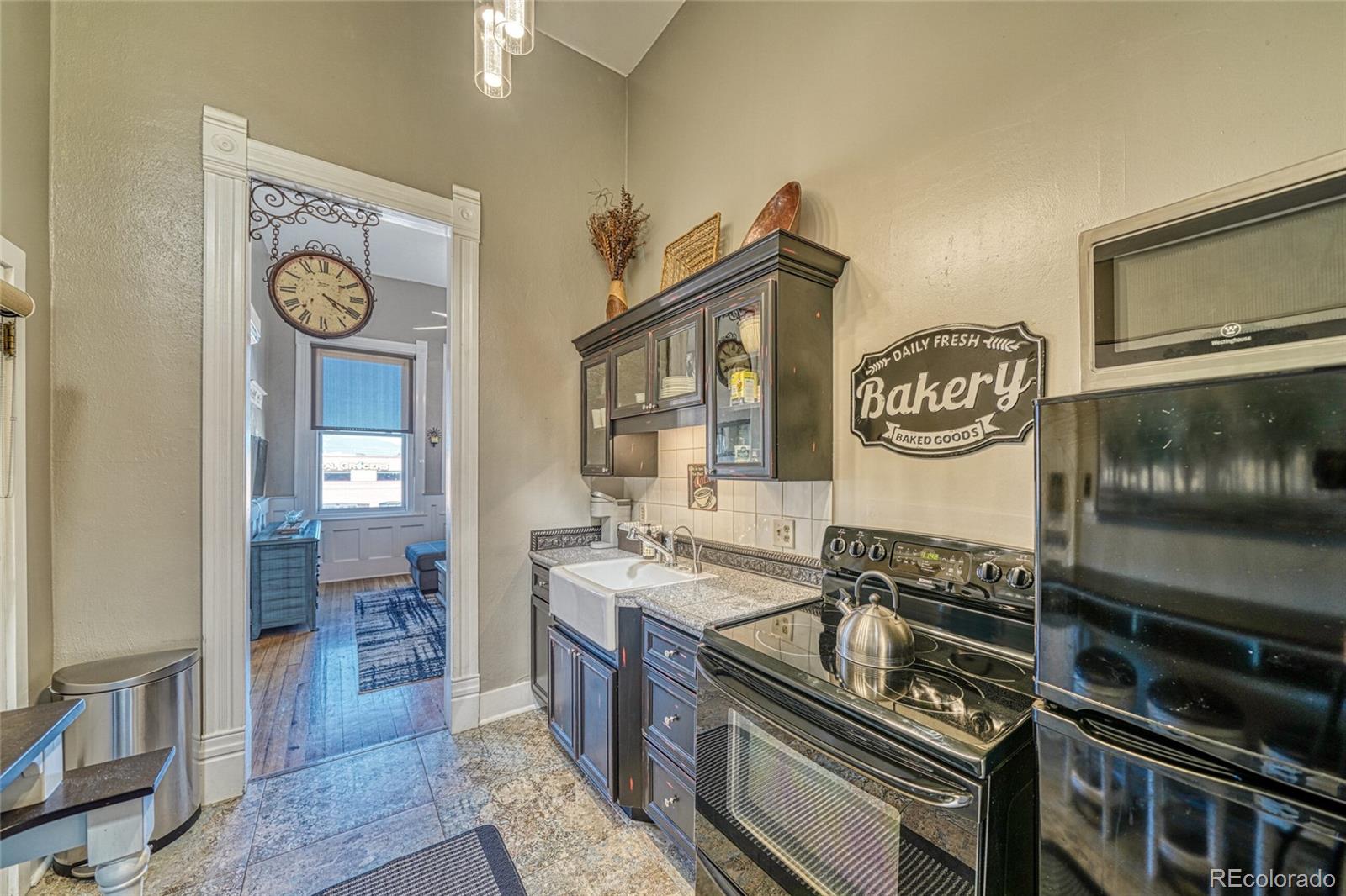 207 F Street, Unit 2 Salida, CO 81201 - Photo 10 of 23 a kitchen with stainless steel appliances granite countertop a stove and a microwave