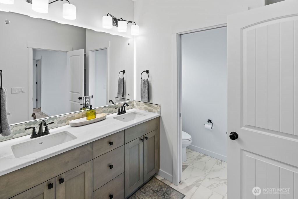 231 Shrute Road Prosser, WA 99350 - Photo 16 of 36 a bathroom with a double vanity sink and a mirror