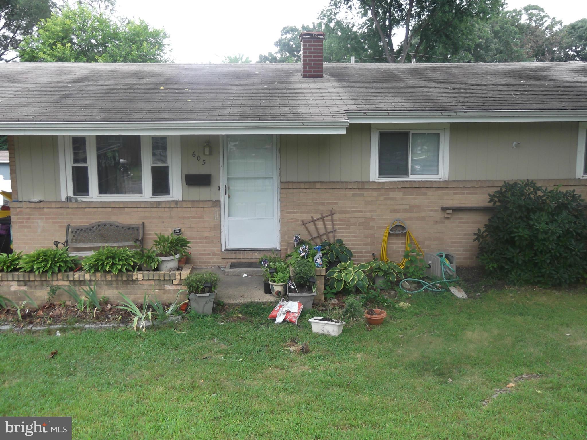 605 Eliot Road Pasadena, MD 21122 - Photo 3 of 4 a front view of a house with a garden
