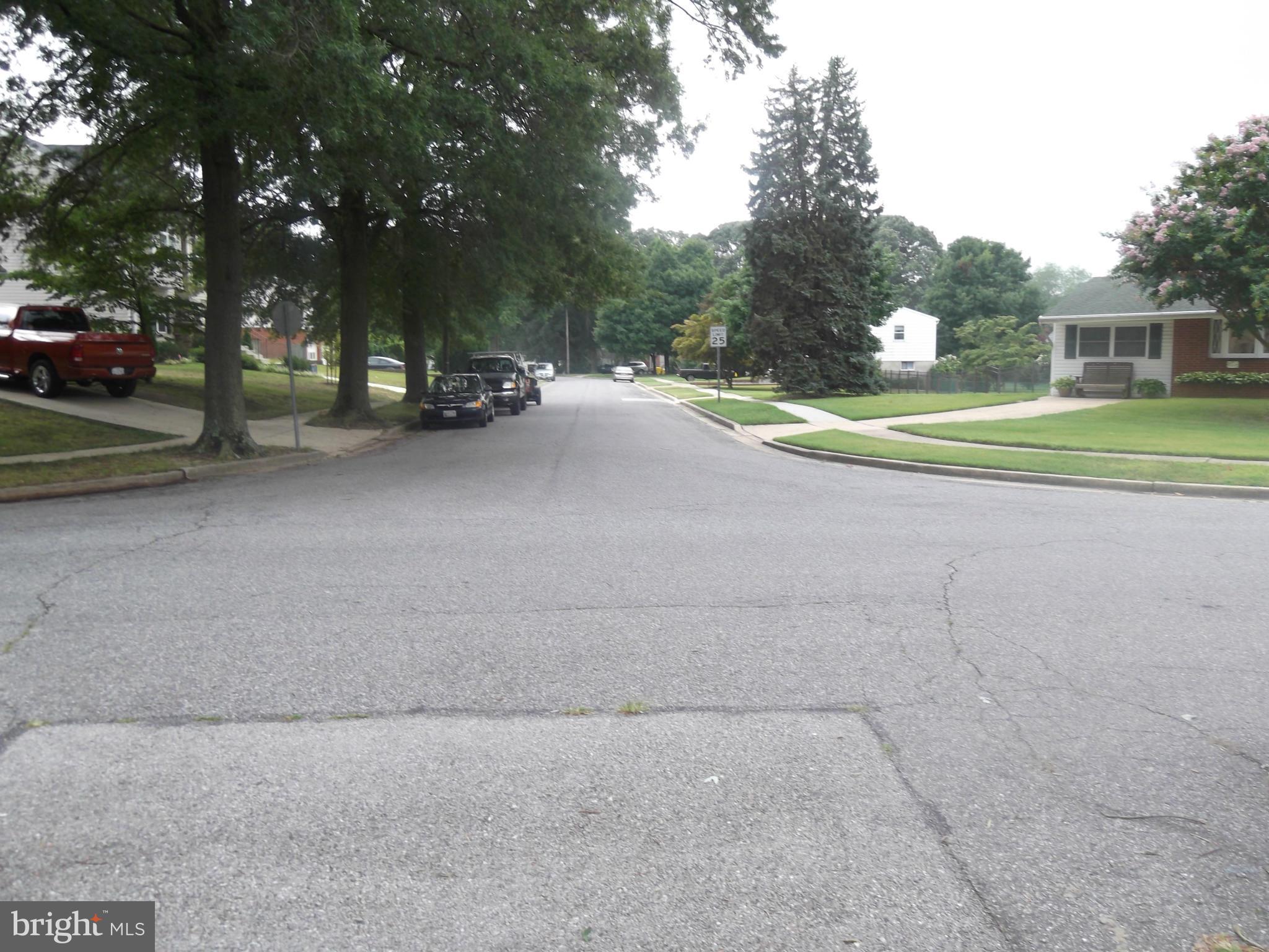 605 Eliot Road Pasadena, MD 21122 - Photo 4 of 4 a view of a road with trees