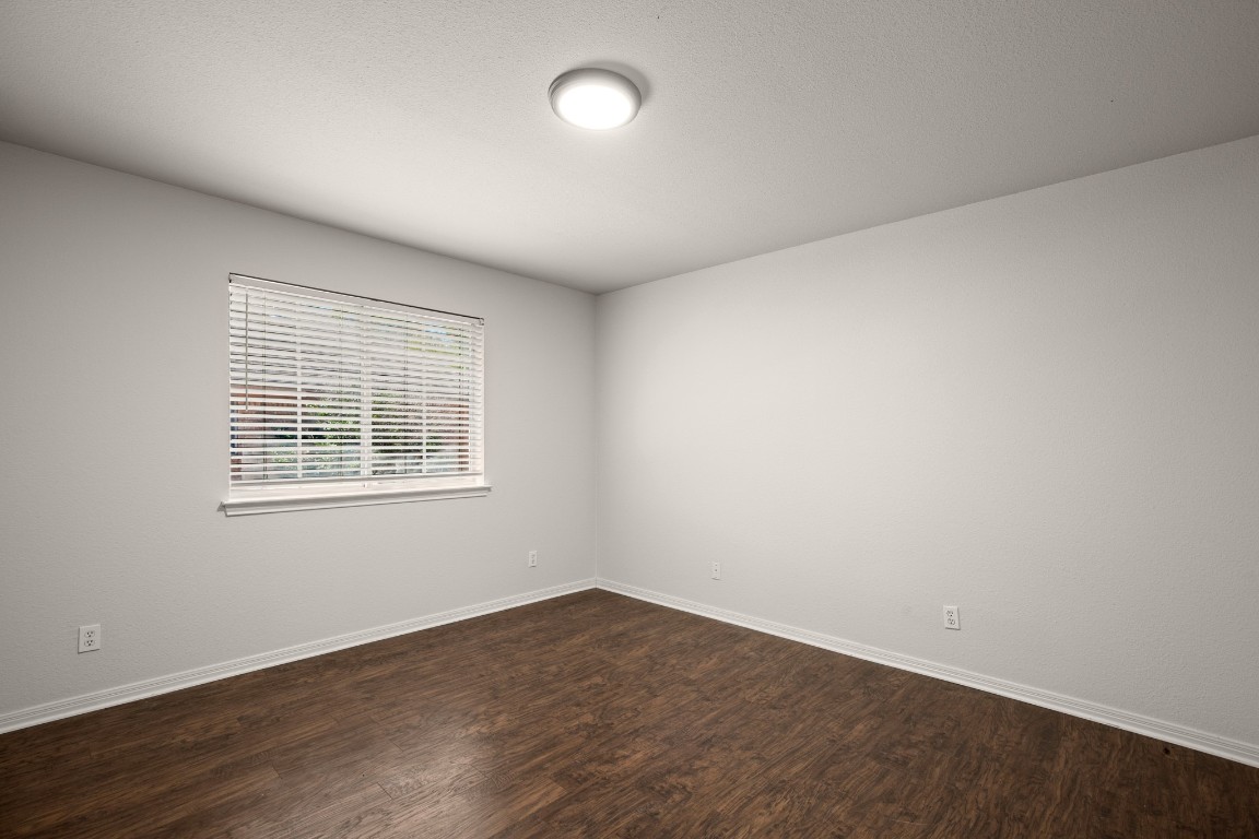 1206 Brophy Drive Pflugerville, TX 78660 - Photo 24 of 29 an empty room with wooden floor and windows