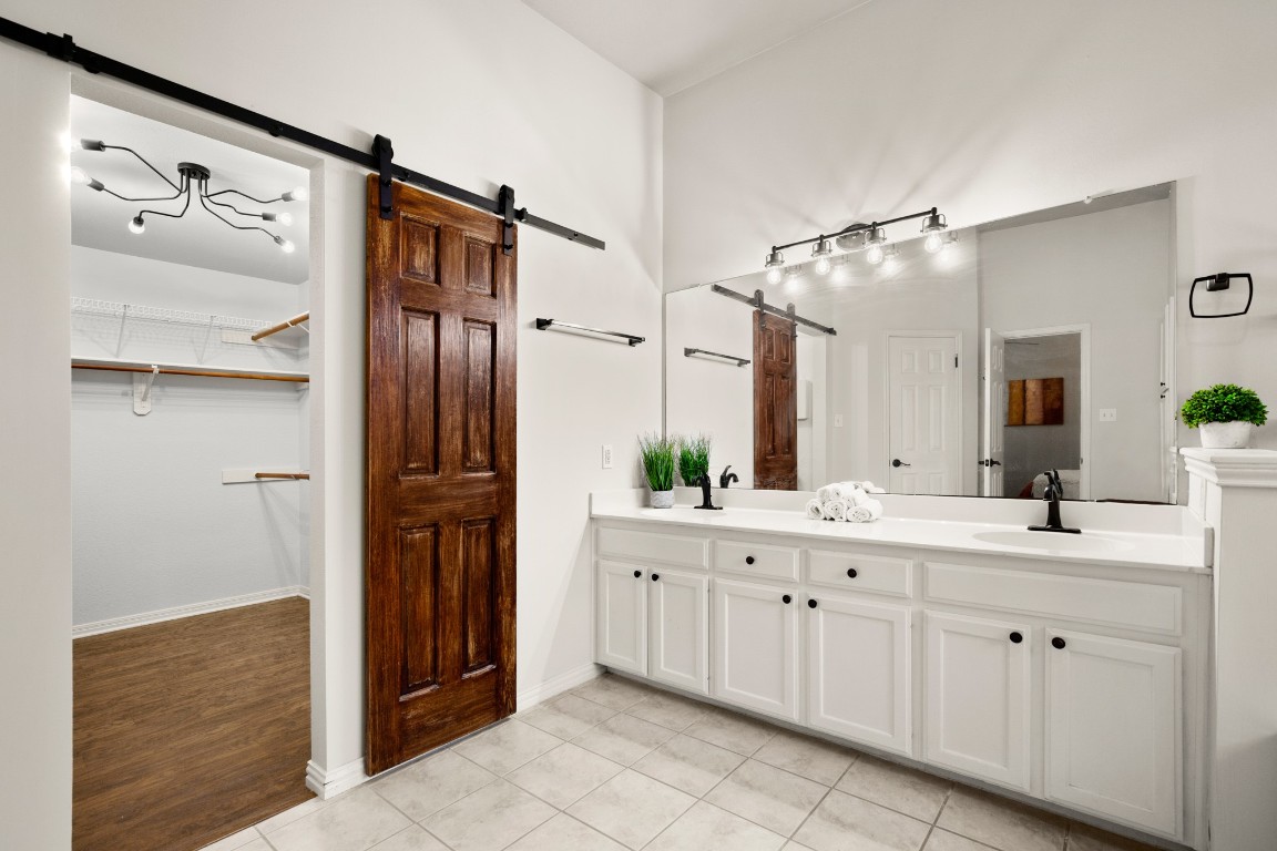 1206 Brophy Drive Pflugerville, TX 78660 - Photo 3 of 29 a spacious bathroom with a double vanity sink a mirror and shower