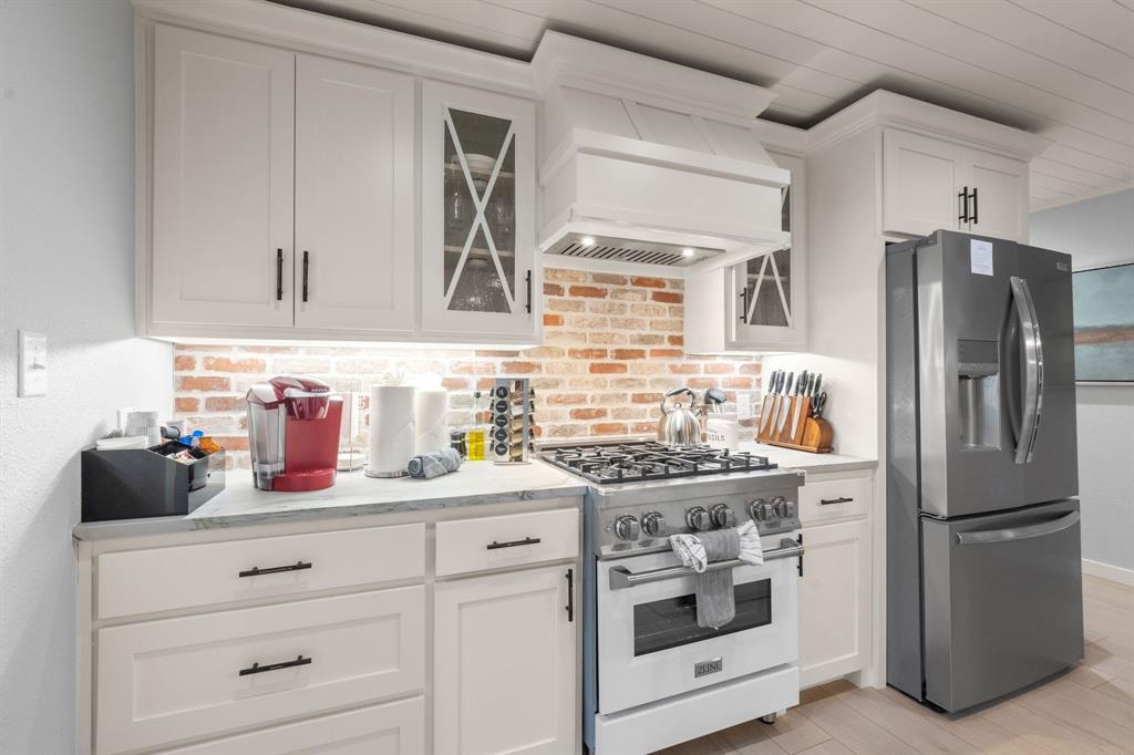 408 East Liberty Street Pilot Point, TX 76258 - Photo 13 of 31 a kitchen with stainless steel appliances a sink stove and refrigerator