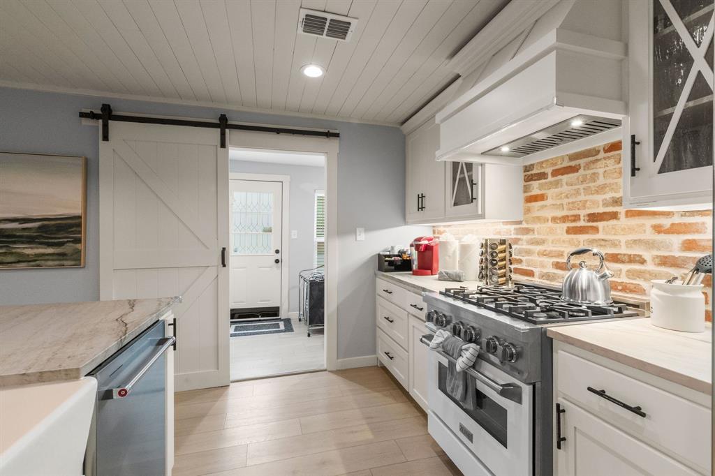 408 East Liberty Street Pilot Point, TX 76258 - Photo 15 of 31 a kitchen with stainless steel appliances a stove and a refrigerator