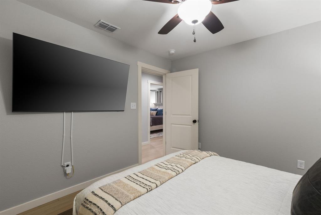 408 East Liberty Street Pilot Point, TX 76258 - Photo 20 of 31 a bedroom with a bed and a flat screen tv