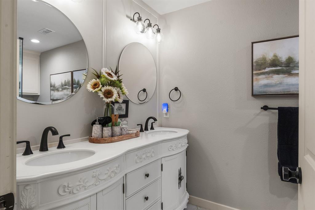 408 East Liberty Street Pilot Point, TX 76258 - Photo 25 of 31 a bathroom with a sink and a mirror