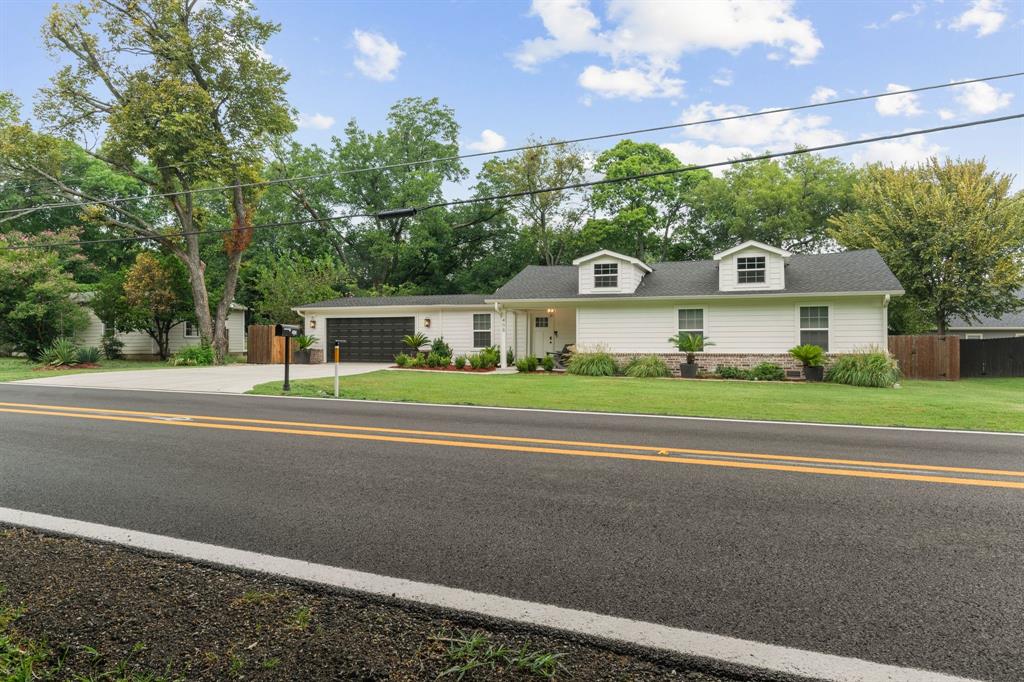 408 East Liberty Street Pilot Point, TX 76258 - Photo 3 of 31 a view of a house with a big yard and large trees