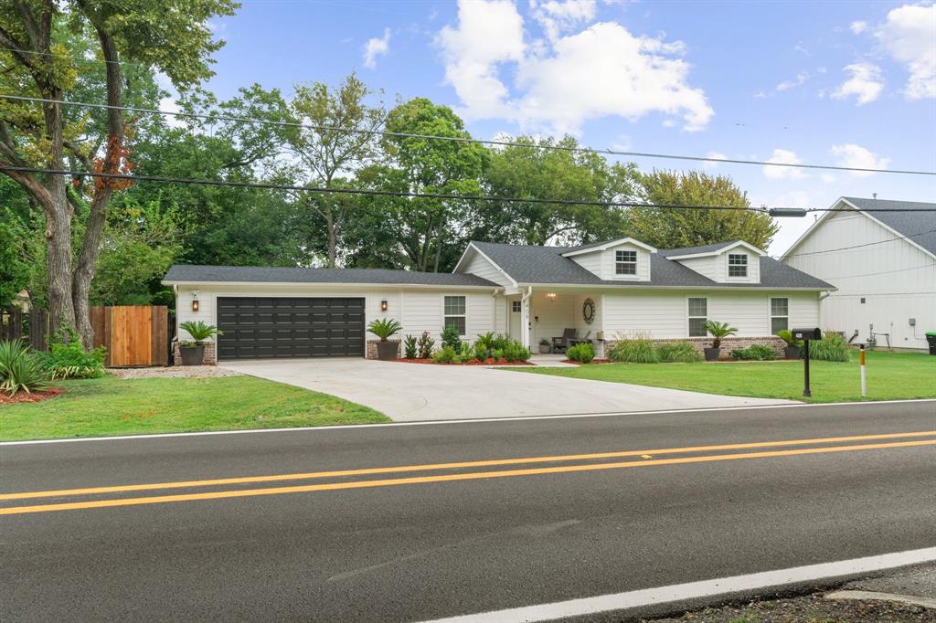 408 East Liberty Street Pilot Point, TX 76258 - Photo 4 of 31 a front view of a house with a yard and table and chairs