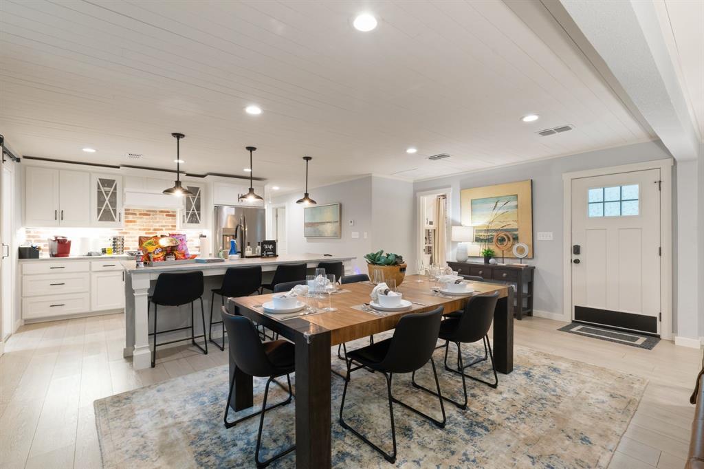 408 East Liberty Street Pilot Point, TX 76258 - Photo 10 of 31 a kitchen with kitchen island a table and chairs in it