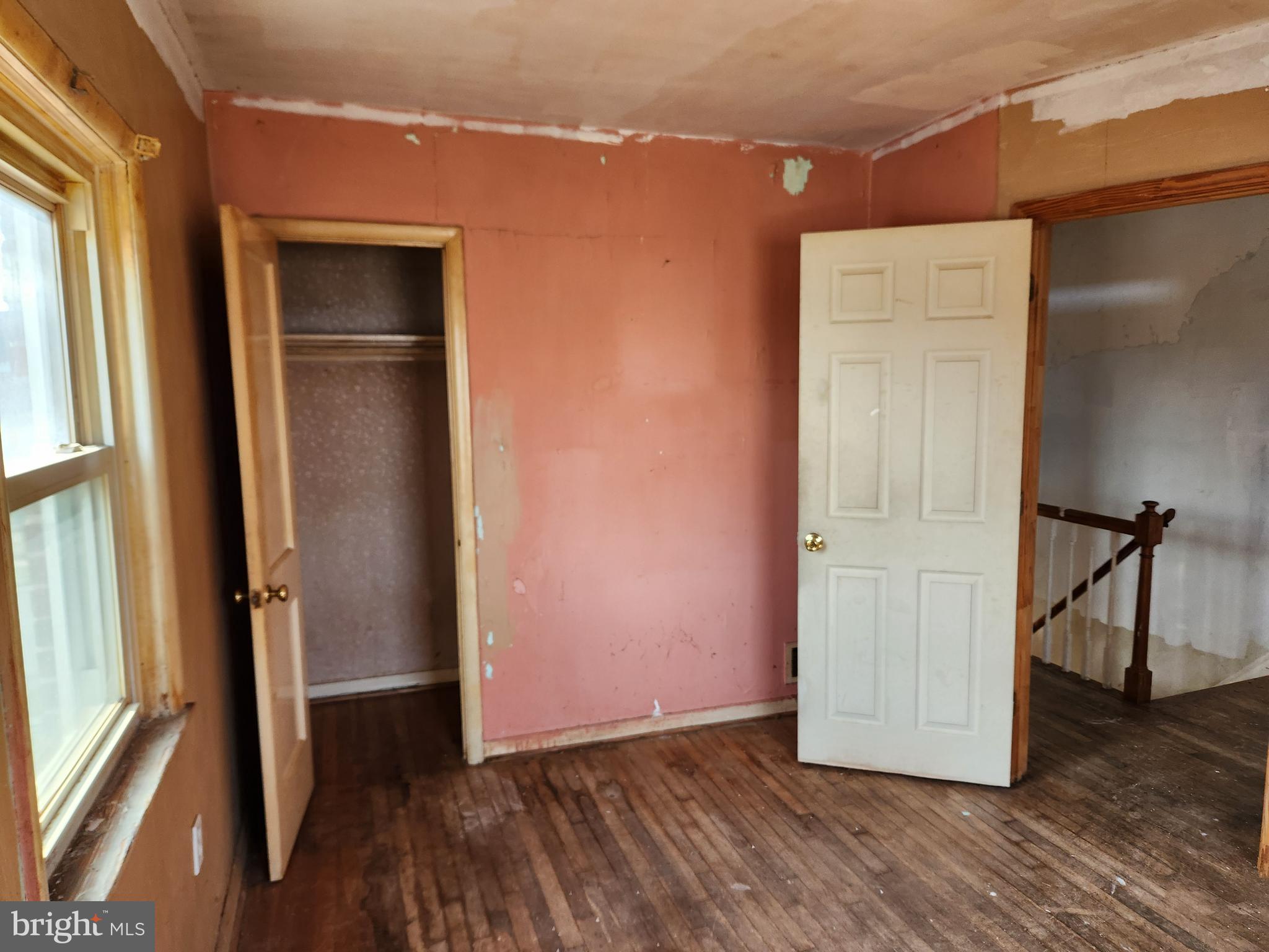 2041 Jasmine Road Baltimore, MD 21222 - Photo 11 of 21 an empty room with wooden floor and windows