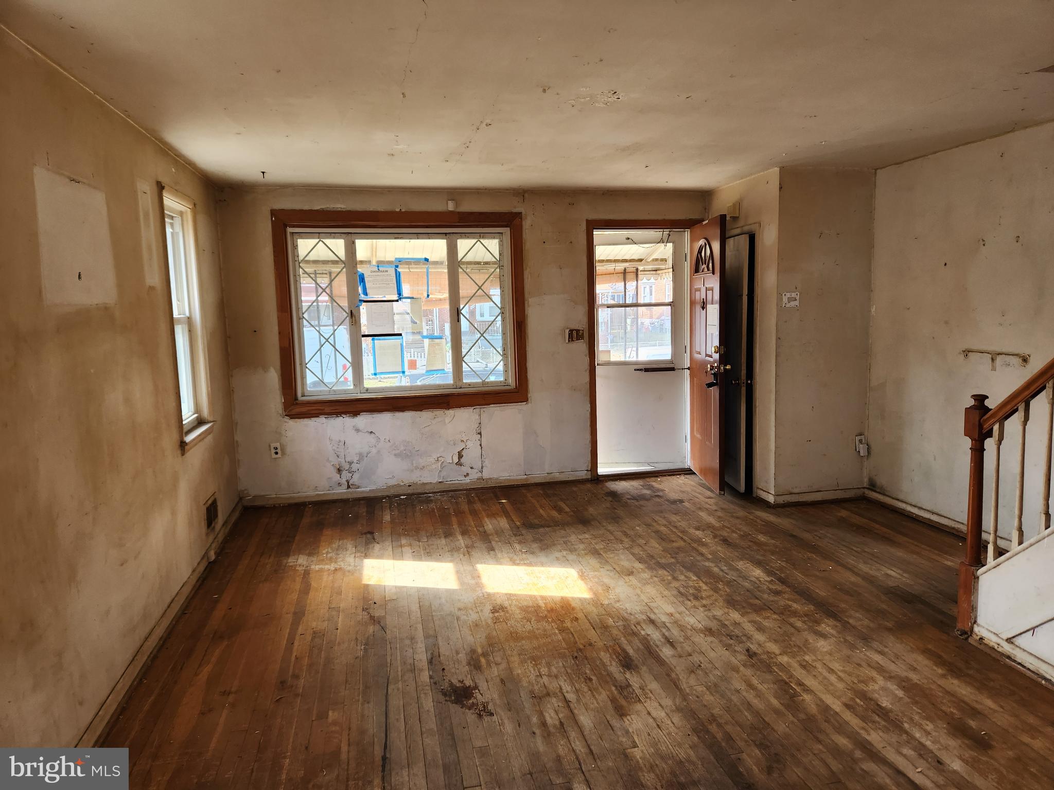 2041 Jasmine Road Baltimore, MD 21222 - Photo 4 of 21 an empty room with wooden floor and windows