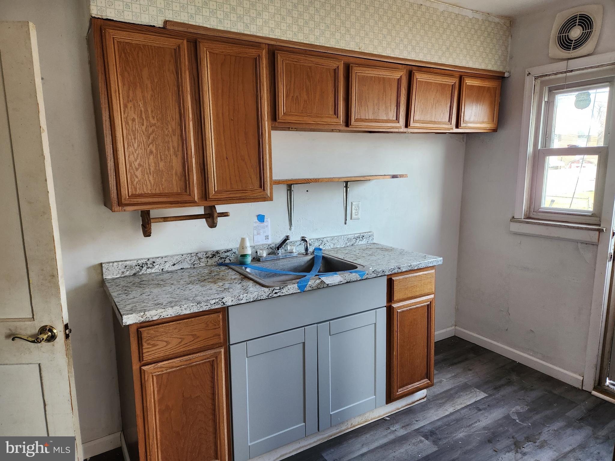 2041 Jasmine Road Baltimore, MD 21222 - Photo 7 of 21 a kitchen with stainless steel appliances granite countertop a sink stove and cabinets