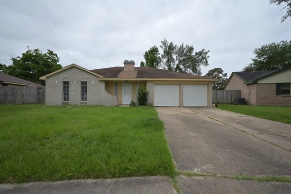 a front view of house with a garden