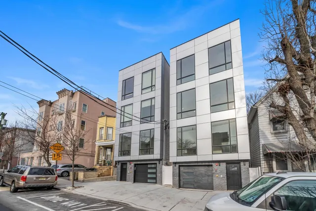 a city street lined with parked cars and buildings