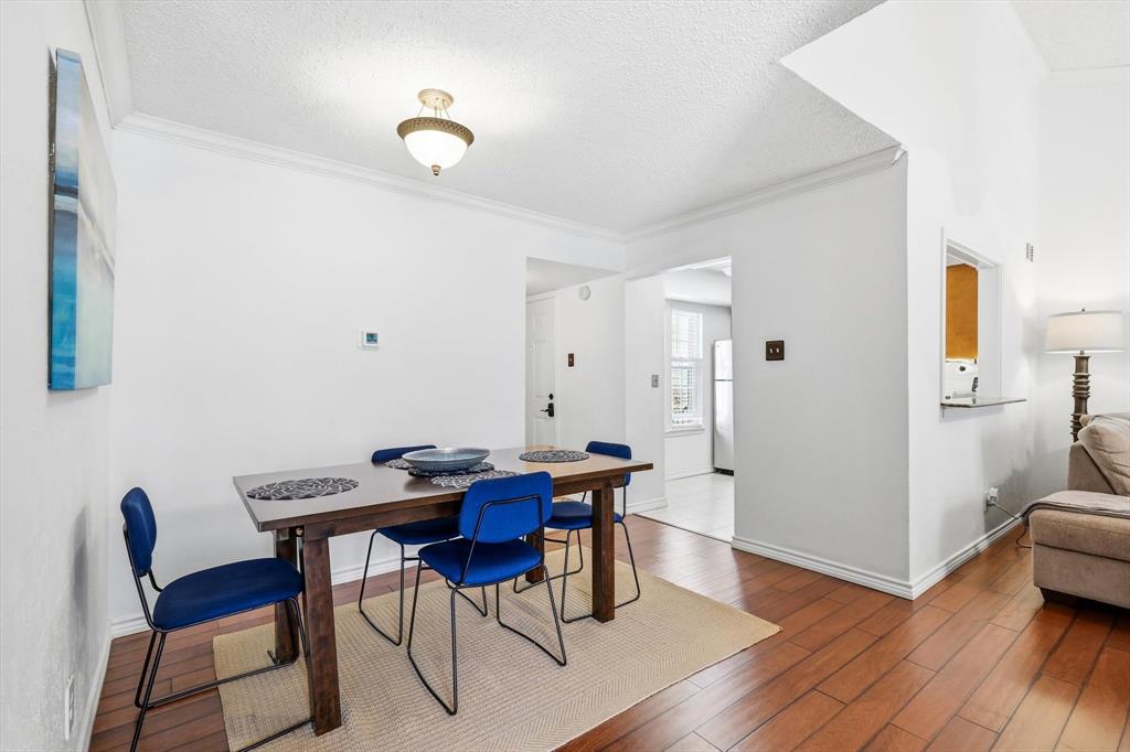 5300 Keller Springs Road, Unit 2057 Dallas, TX 75248 - Photo 11 of 35 a view of a dining room with furniture and wooden floor