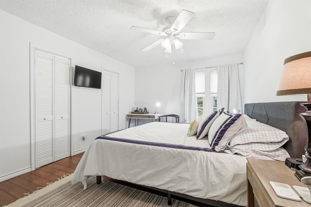 5300 Keller Springs Road, Unit 2057 Dallas, TX 75248 - Photo 23 of 35 a bedroom with a bed and a chandelier