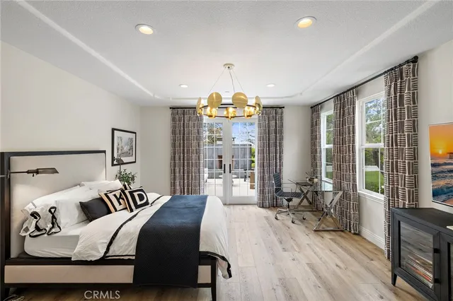 a bathroom with a tub a sink and a window