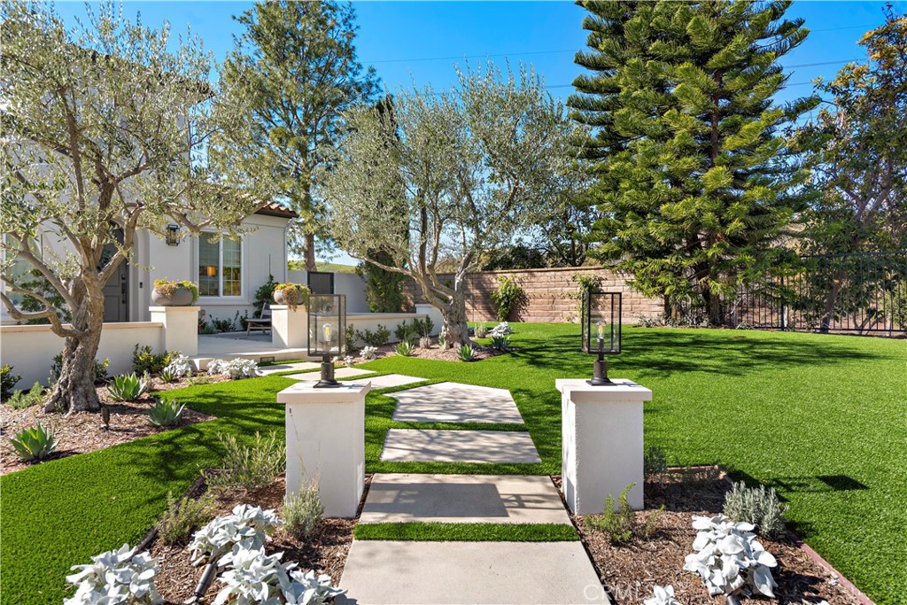 1 Drackert Lane Ladera Ranch, CA 92694 - Photo 3 of 57 a view of a patio with table and chairs potted plants and a large tree