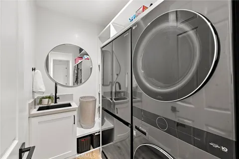 a view of a patio with couches table and chairs with potted plants and a large tree