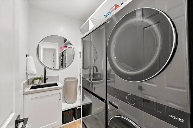 a view of a patio with couches table and chairs with potted plants and a large tree