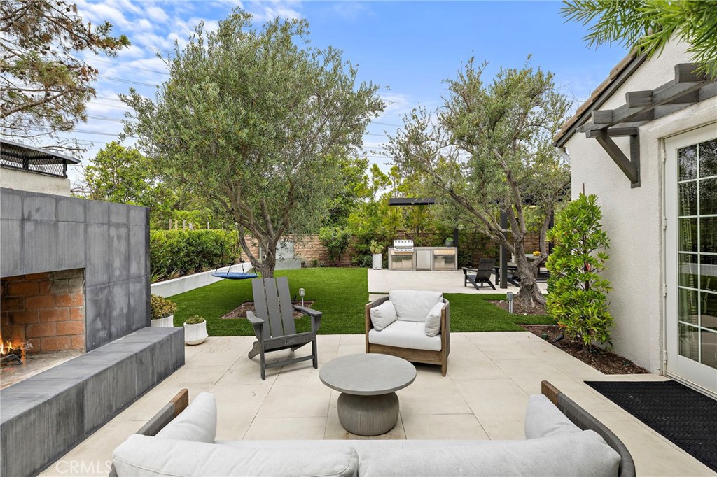 1 Drackert Lane Ladera Ranch, CA 92694 - Photo 36 of 57 a view of a patio with couches table and chairs with potted plants and a large tree