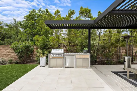 a porch with seating space and trees in the background