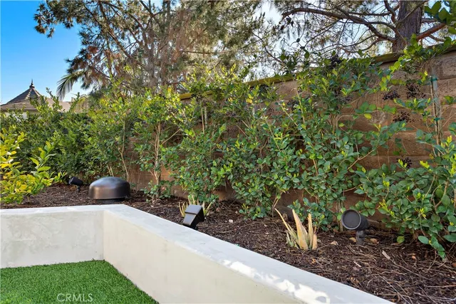 an aerial view of a house with a yard and outdoor seating