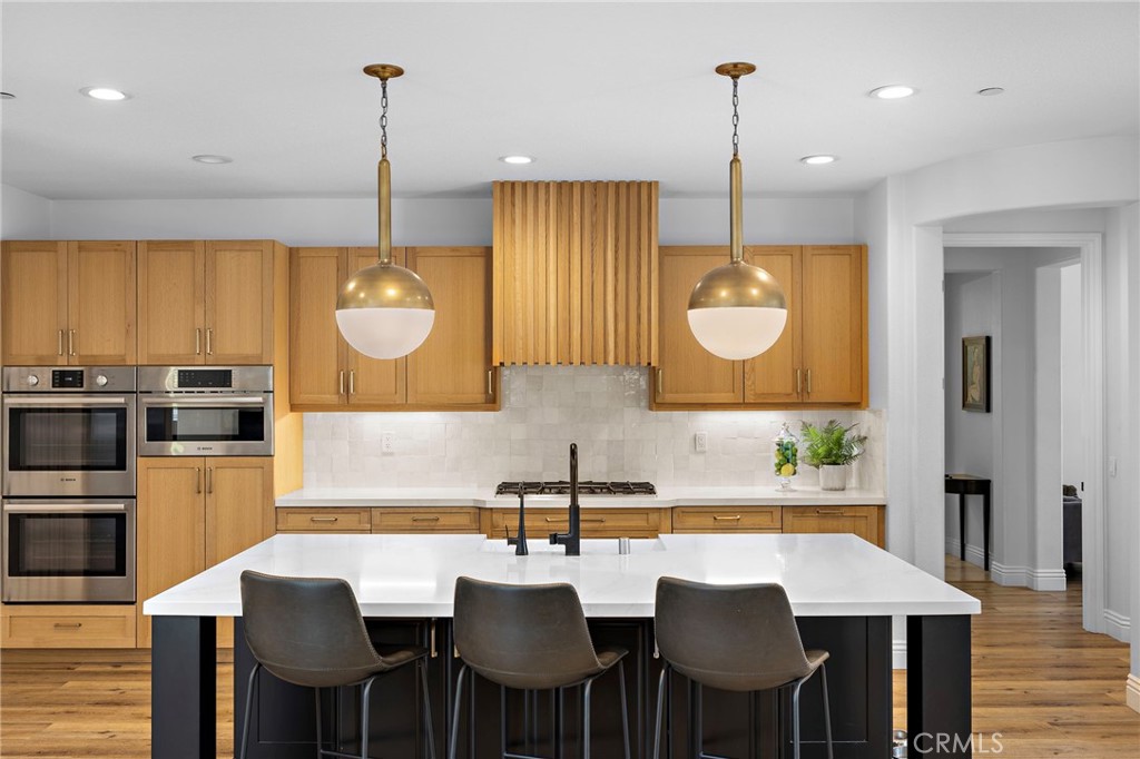 1 Drackert Lane Ladera Ranch, CA 92694 - Photo 9 of 57 a kitchen with a table chairs sink and cabinets