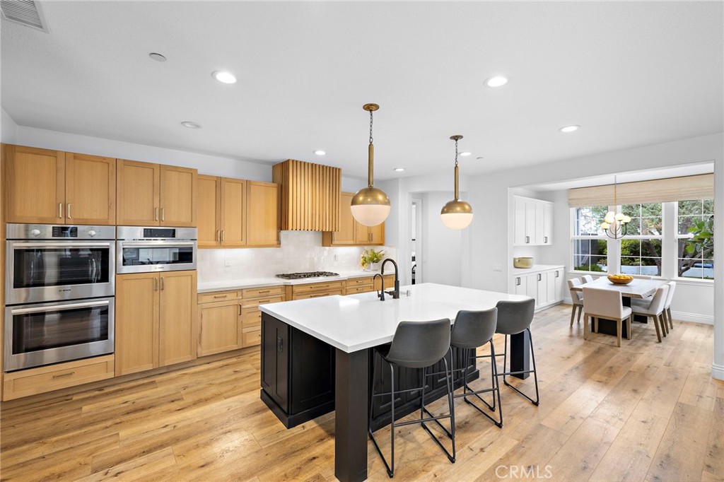 1 Drackert Lane Ladera Ranch, CA 92694 - Photo 10 of 57 a large kitchen with a table and chairs
