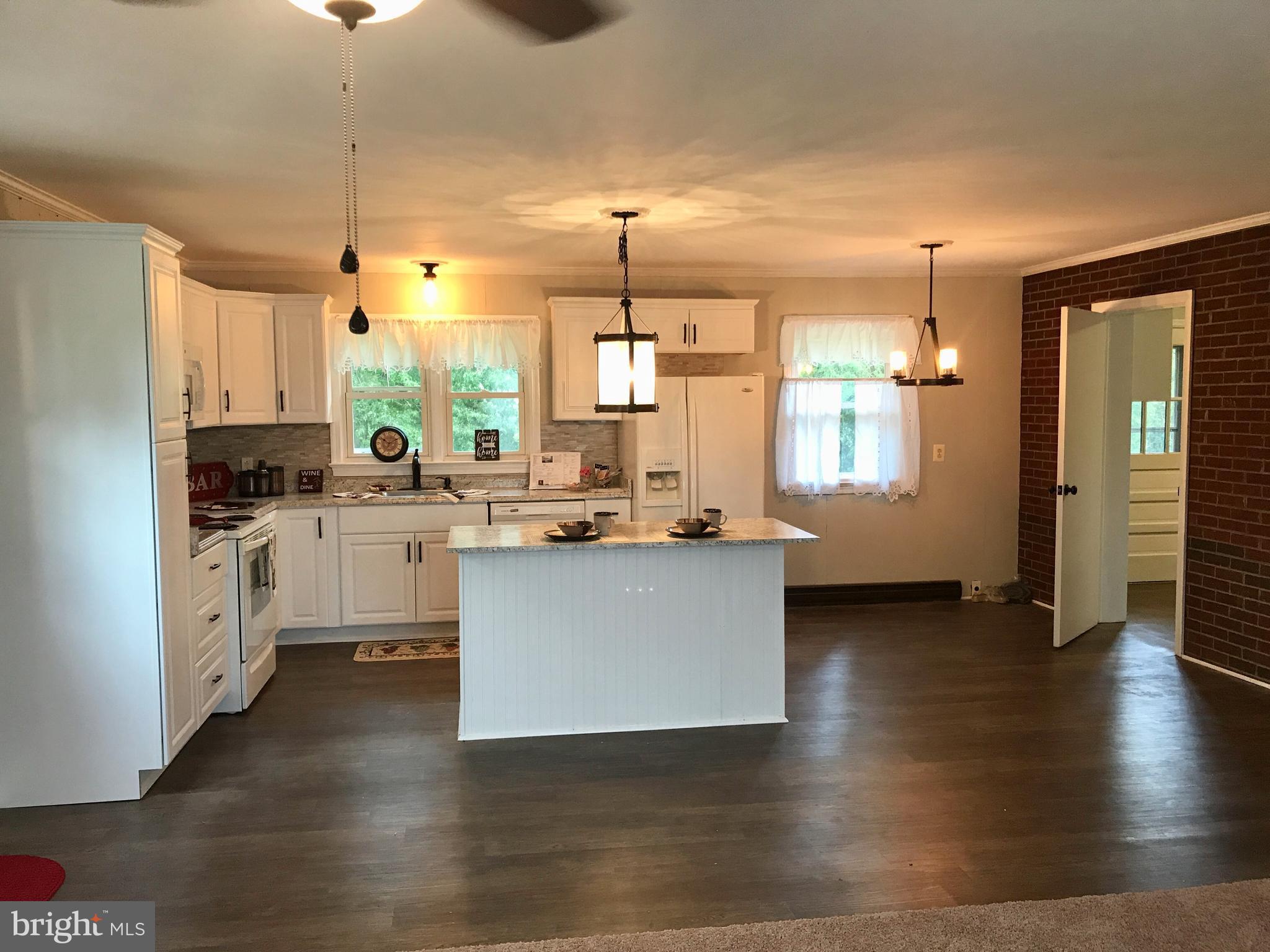 9671 Clarkes Road Bealeton, VA 22712 - Photo 2 of 12 a kitchen with a refrigerator cabinets and wooden floor