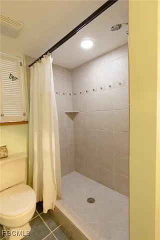 a bathroom with a shower and a toilet