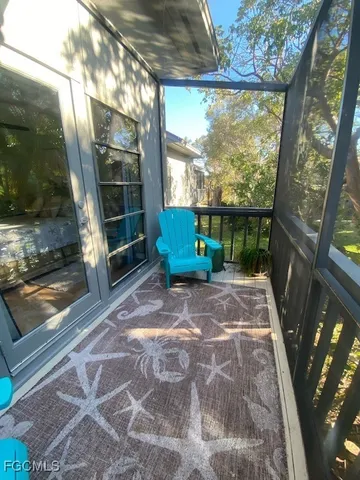 a backyard of a house with outdoor seating and windows