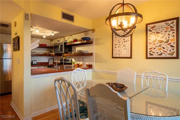 a view of a dining room with furniture and chandelier